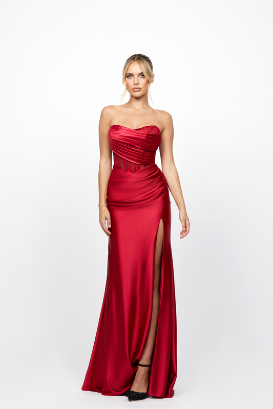 Red strapless gown with a slit on a white background